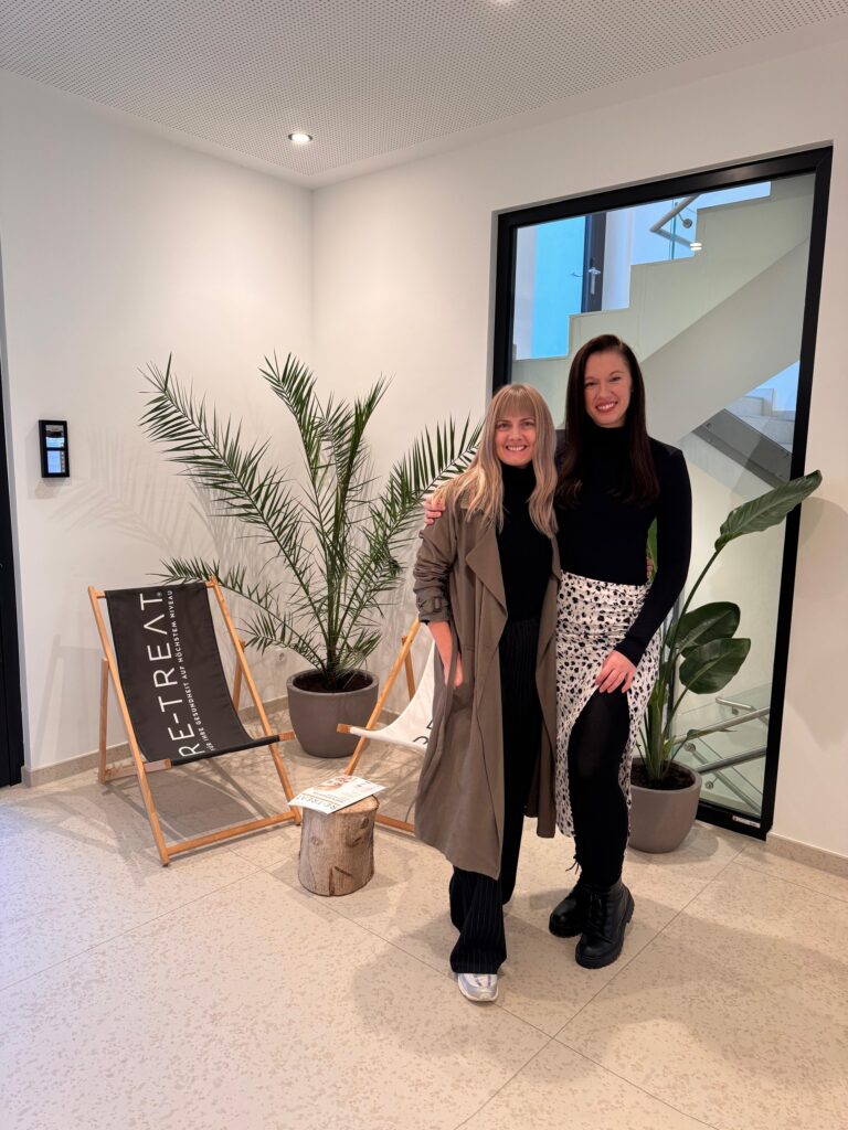two female yoga teachers smiling