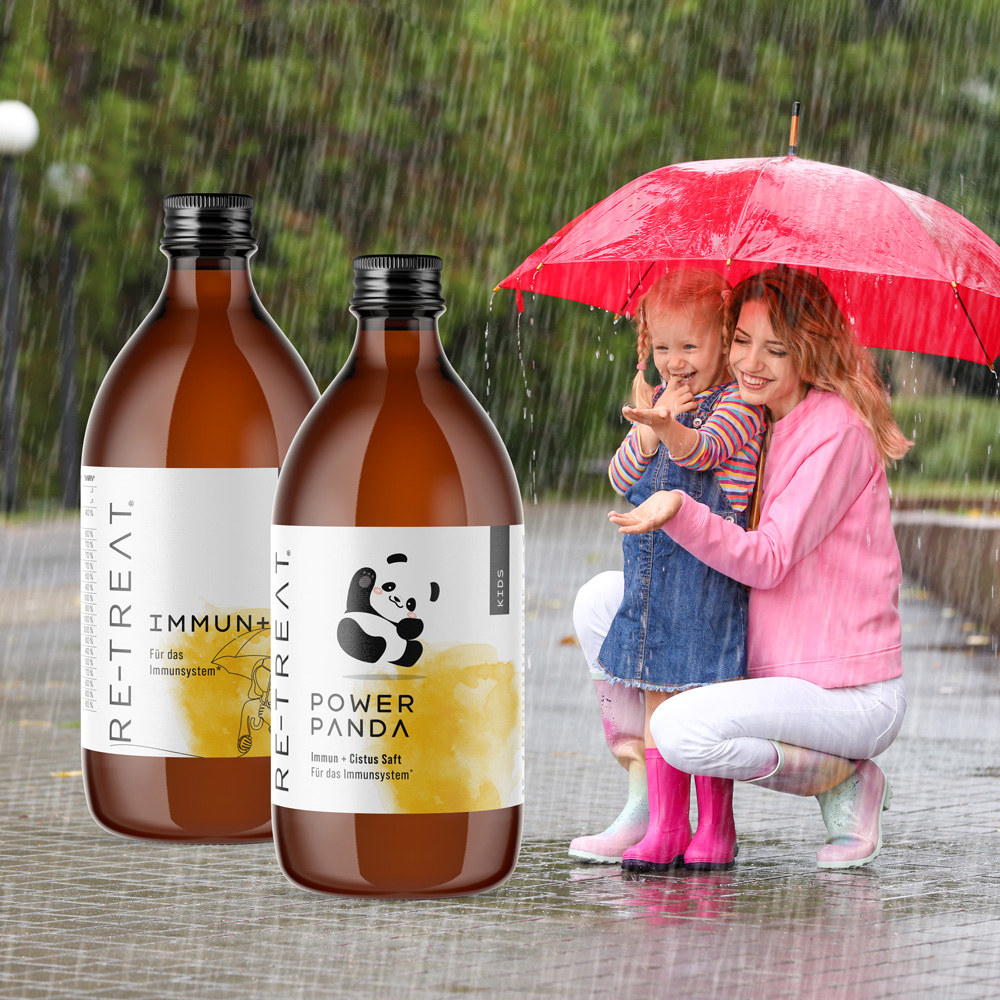 Mutter mit Kind steht unter Regenschirm immun+ als Packshot im Vordergrund